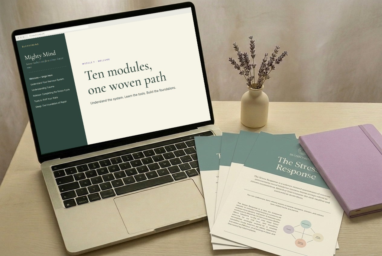 A laptop with the course open beside printed handouts and lavender